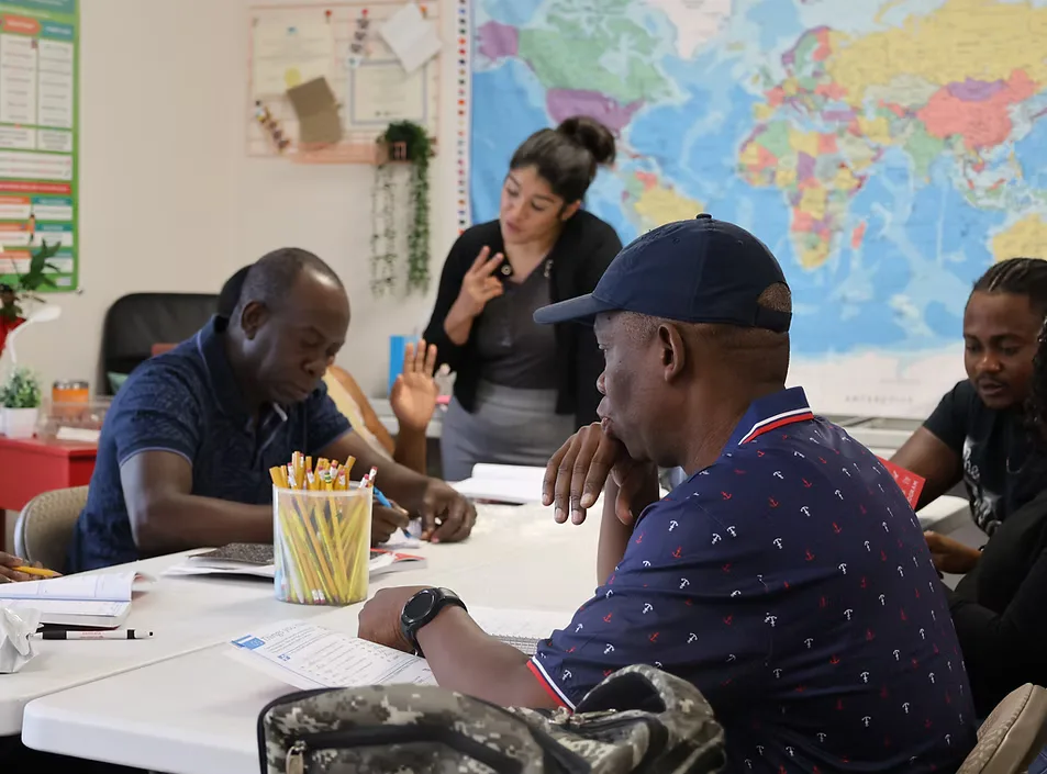 An EAL teacher working with students at Cactus Nazarene Ministry Center