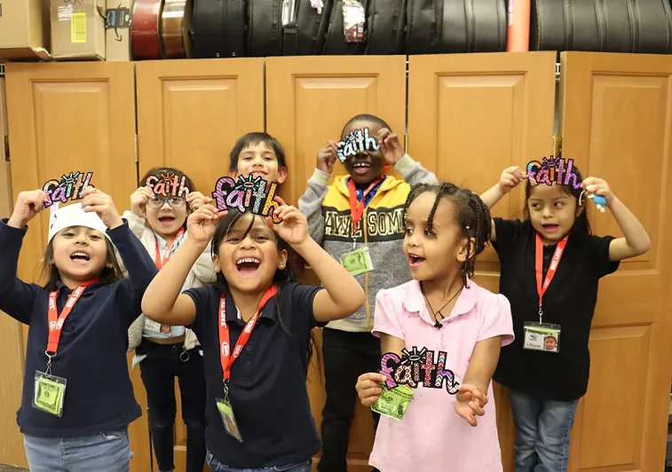 Children at CNMC holding up letter crafts spelling FAITH